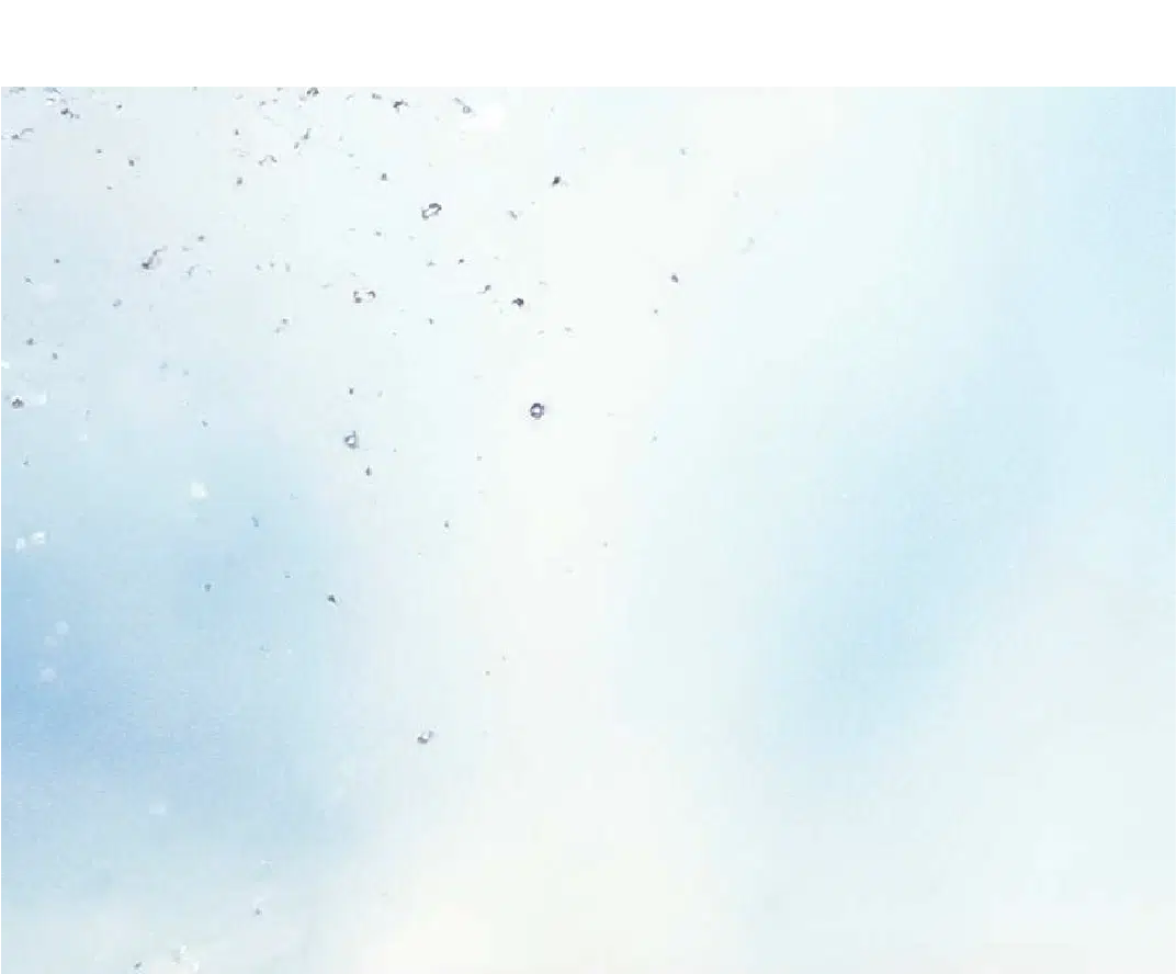 A light blue and white gradient background with small scattered specks and spots, resembling dust or water droplets on a surface.